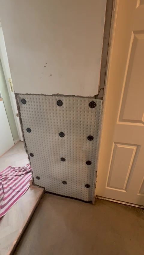 Membrane fitted to the wall beside the doorway.